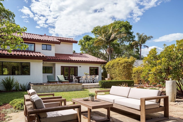 back of house featuring outdoor lounge area, stucco siding, french doors, a patio area, and a tile roof