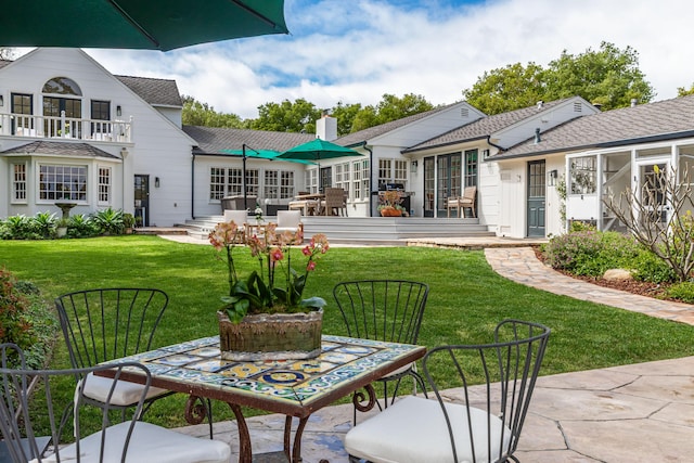 935 Arcady Rd, Santa Barbara, CA 93108 - back of property with a shingled roof, a lawn, and a chimney