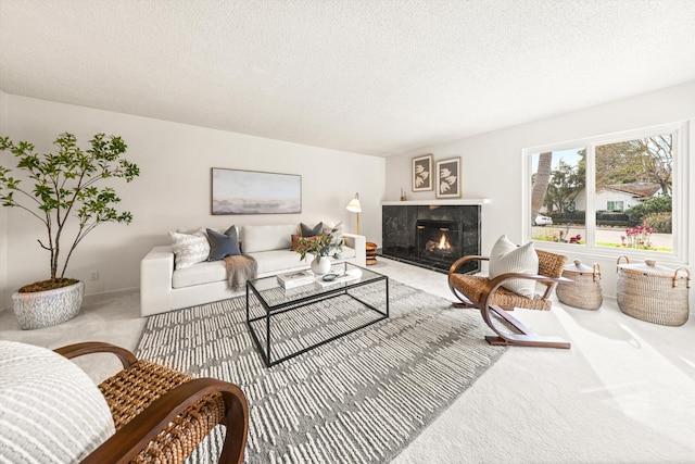 carpeted living room featuring a textured ceiling and a premium fireplace
