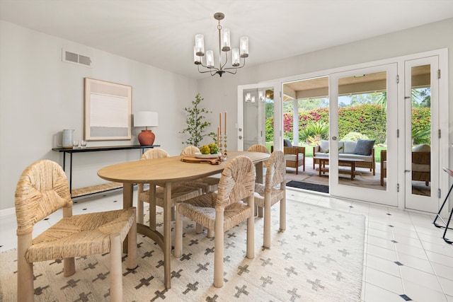 dining room with a chandelier and visible vents
