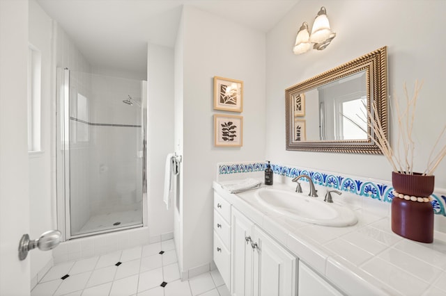 full bath featuring vanity, tile patterned flooring, and a stall shower