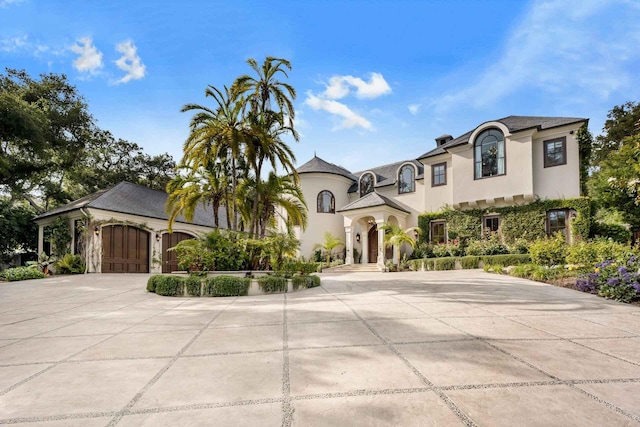2084 E Valley Rd, Montecito, CA 93108 - mediterranean / spanish-style home with stucco siding, an attached garage, and curved driveway