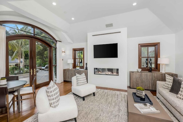 2084 E Valley Rd, Montecito, CA 93108 - living area featuring a glass covered fireplace, vaulted ceiling, recessed lighting, french doors, and visible vents