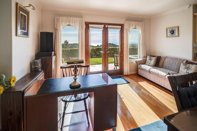 living area with a wealth of natural light, french doors, ornamental molding, and wood finished floors