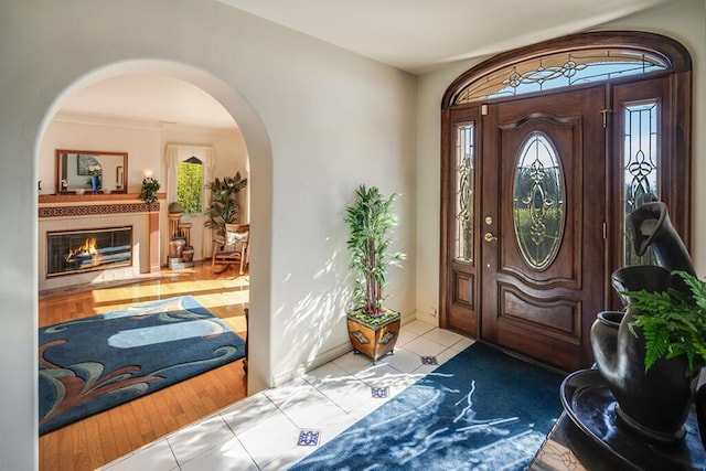 tiled entrance foyer with arched walkways