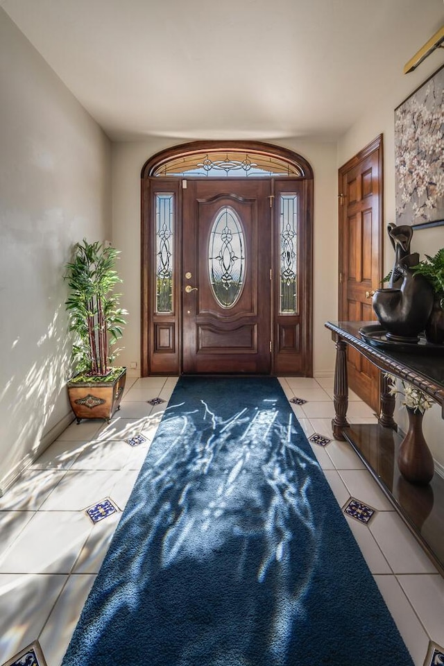 foyer entrance with light tile patterned flooring