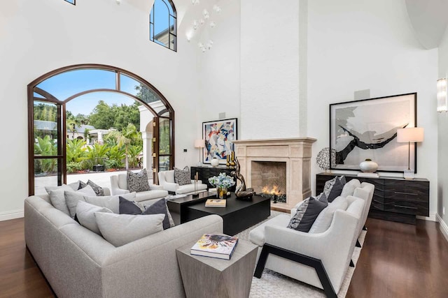 2084 E Valley Rd Unit 1, Santa Barbara, CA 93108 - living room featuring baseboards, wood finished floors, a towering ceiling, and a high end fireplace