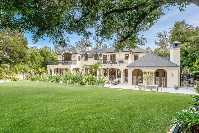 2084 E Valley Rd Unit 1, Santa Barbara, CA 93108 - back of house featuring fence, a balcony, french doors, and a chimney
