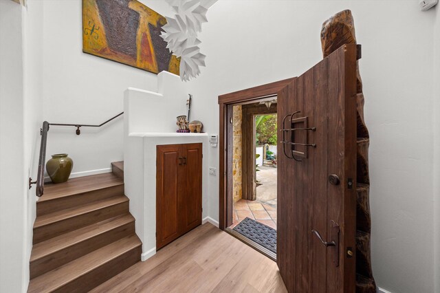 1435 Sycamore Canyon Rd, Santa Barbara, CA 93108 - entrance foyer featuring light wood finished floors, stairway, and baseboards