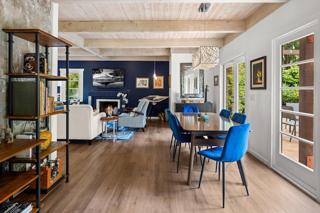 1435 Sycamore Canyon Rd, Santa Barbara, CA 93108 - dining space with wood finished floors, wood ceiling, a lit fireplace, beamed ceiling, and healthy amount of natural light