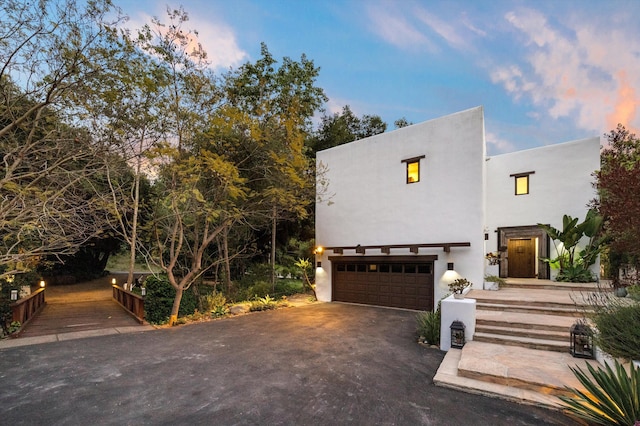 1435 Sycamore Canyon Rd, Santa Barbara, CA 93108 - view of front of home with an attached garage, stucco siding, and driveway