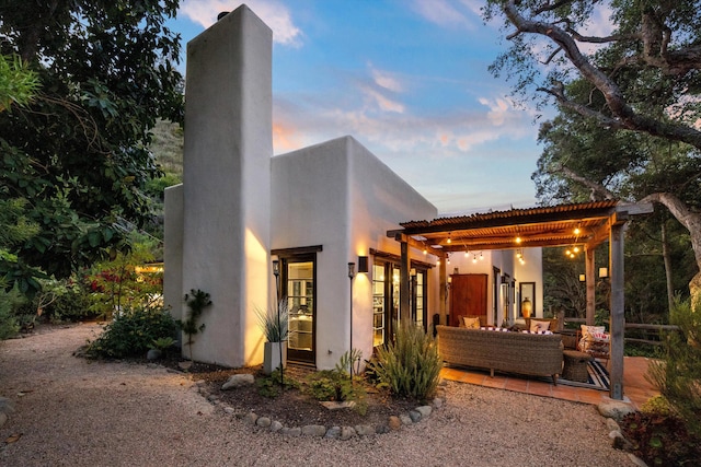 1435 Sycamore Canyon Rd, Santa Barbara, CA 93108 - rear view of property featuring stucco siding, a chimney, and outdoor lounge area