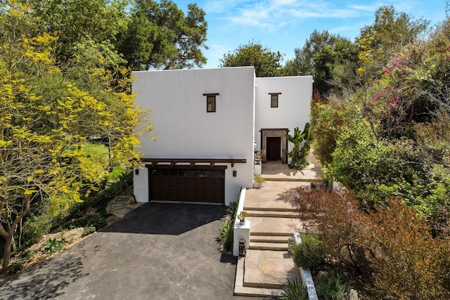 1435 Sycamore Canyon Rd, Santa Barbara, CA 93108 - view of front of house with stucco siding, driveway, and a garage