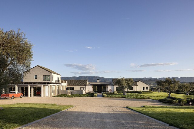 2794 Kara Ln, Solvang, CA 93463 - view of front of property with a front yard, stucco siding, and a mountain view