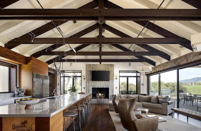 2794 Kara Ln, Solvang, CA 93463 - living area featuring a large fireplace, plenty of natural light, lofted ceiling with beams, and dark wood-style flooring