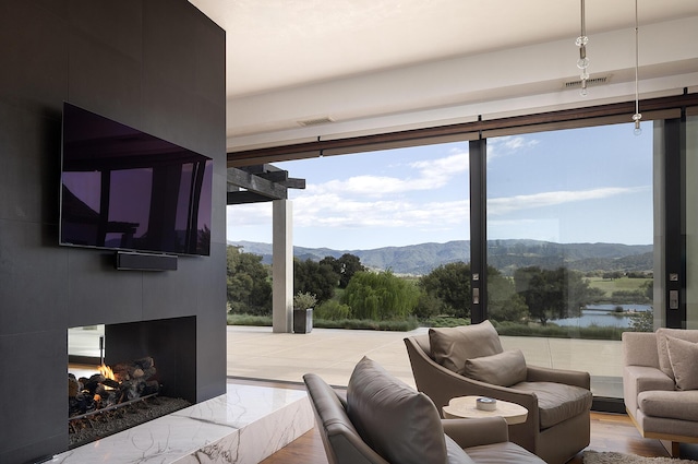 2794 Kara Ln, Solvang, CA 93463 - living area featuring a wall of windows, visible vents, a healthy amount of sunlight, and a fireplace