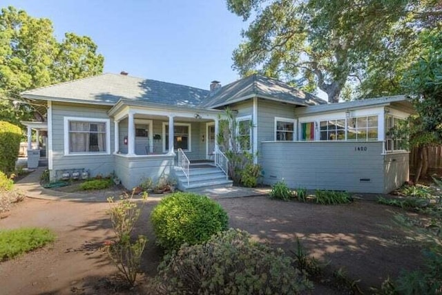 view of front facade with a porch and a sunroom