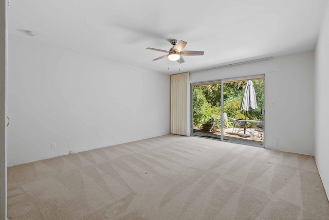 spare room with carpet flooring and a ceiling fan