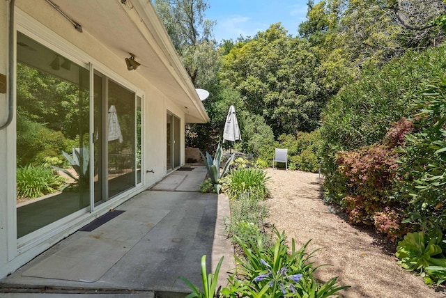 view of property exterior with a patio area
