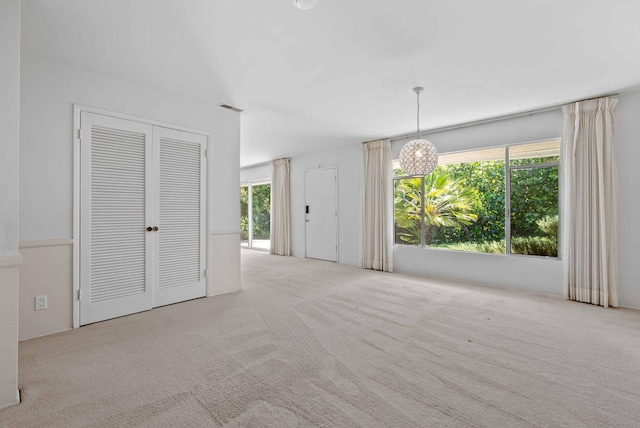 interior space with carpet flooring, visible vents, and a healthy amount of sunlight