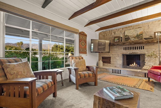 living room with a fireplace, carpet, beam ceiling, and wood ceiling