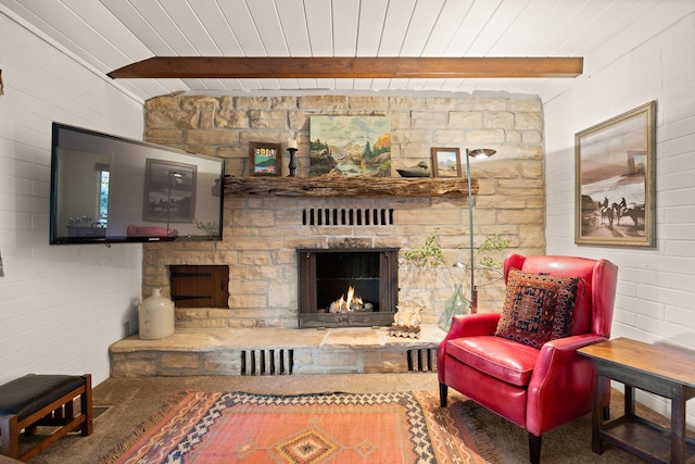 carpeted living area with beamed ceiling, wooden ceiling, and a fireplace