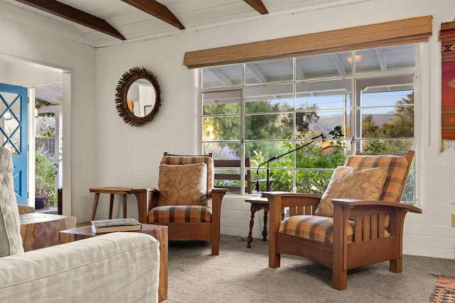 interior space featuring beam ceiling and carpet
