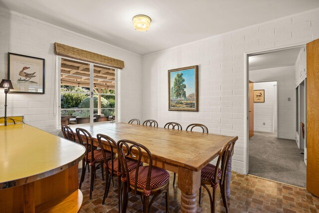 dining room with brick floor