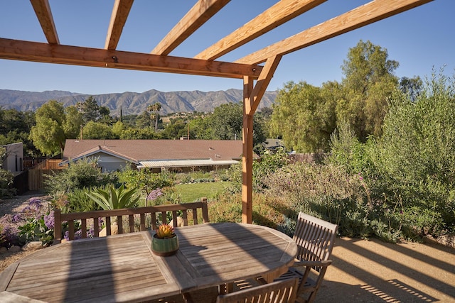 exterior space featuring a pergola, a mountain view, and outdoor dining space
