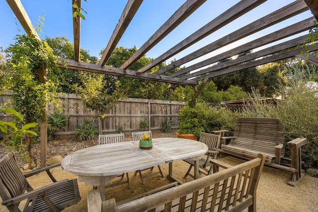 view of patio / terrace with a fenced backyard, a pergola, and outdoor dining space