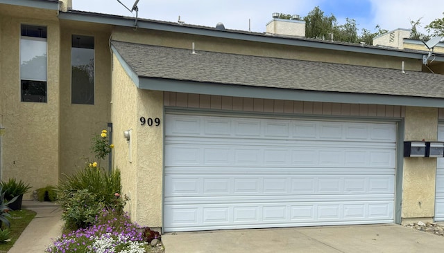 garage with concrete driveway