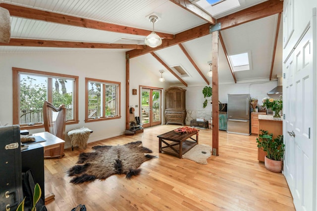 living room with lofted ceiling with skylight, light wood-style floors, and plenty of natural light