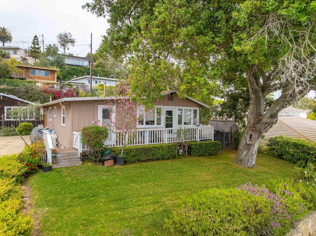 back of property with fence and a yard