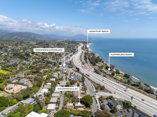 birds eye view of property with a water and mountain view