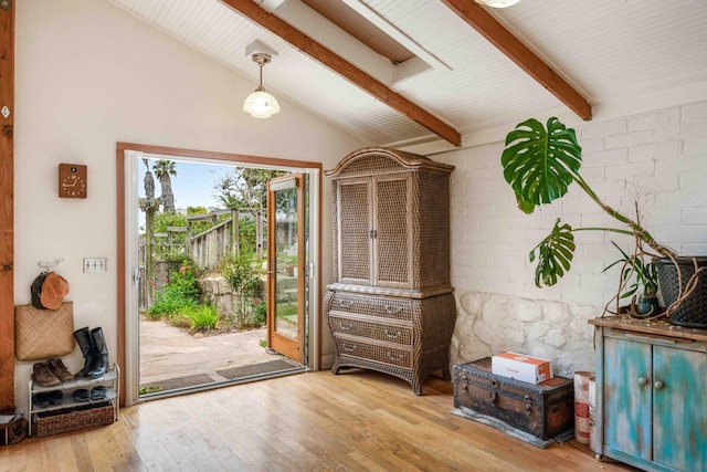 doorway to outside with vaulted ceiling with beams and hardwood / wood-style flooring