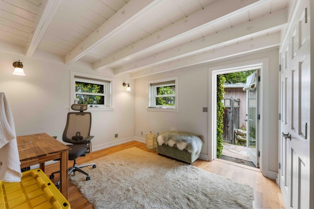 office space featuring baseboards, light wood-type flooring, and beamed ceiling