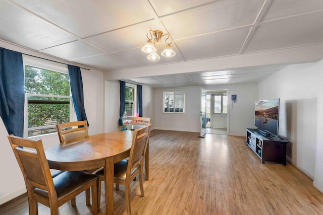 dining room featuring baseboards, a wealth of natural light, and light wood-style floors