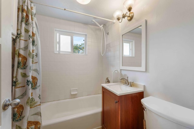 bathroom featuring toilet, vanity, and shower / tub combo with curtain