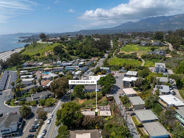 drone / aerial view with a residential view and a water and mountain view