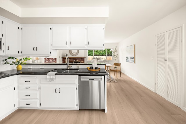 kitchen with a sink, white cabinets, light wood-style floors, and dishwasher