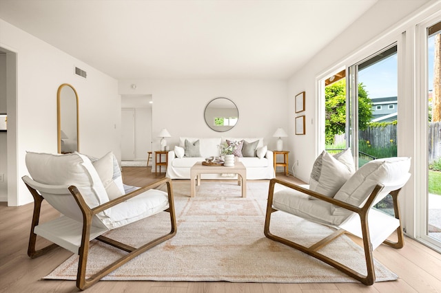 living area featuring visible vents and light wood-style floors