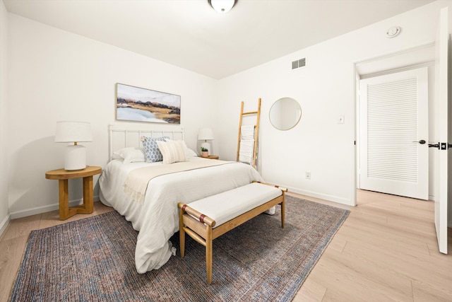 bedroom with visible vents, baseboards, and light wood-style floors