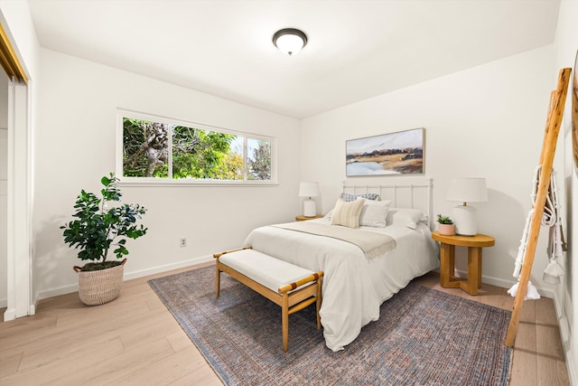 bedroom featuring wood finished floors and baseboards