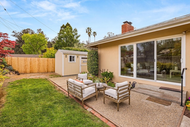 view of yard with a patio, an outdoor structure, a storage shed, an outdoor hangout area, and fence