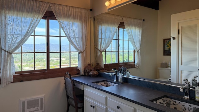 2852 Tapadero Rd, Solvang, CA 93463 - bathroom featuring toilet, vanity, heating unit, and a mountain view