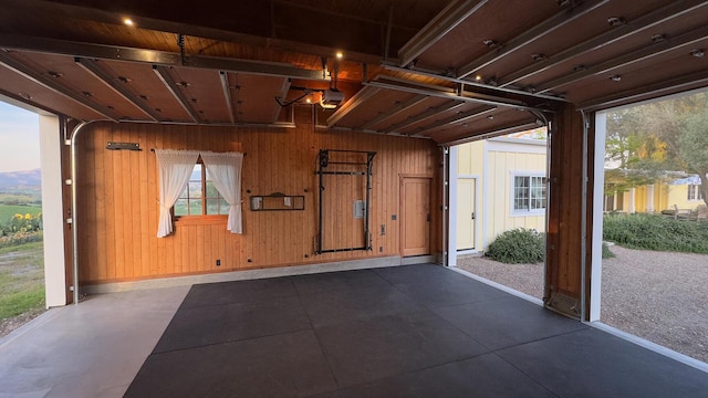 2852 Tapadero Rd, Solvang, CA 93463 - garage with wooden walls, baseboards, and a garage door opener