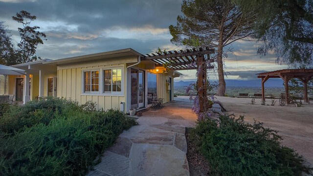 2852 Tapadero Rd, Solvang, CA 93463 - view of side of home featuring a pergola, a patio area, and board and batten siding
