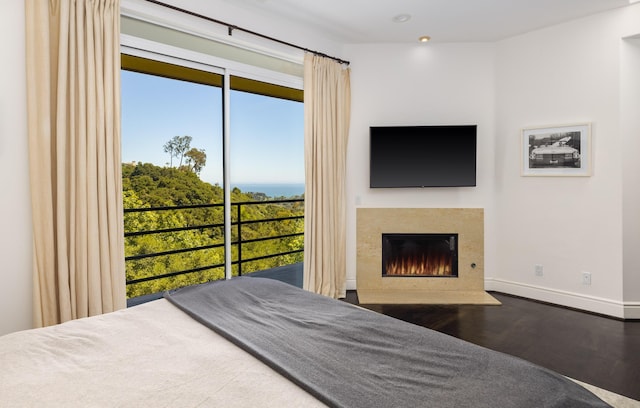 1776 Eucalyptus Hill Rd, Santa Barbara, CA 93103 - bedroom featuring wood finished floors, baseboards, and a fireplace with flush hearth