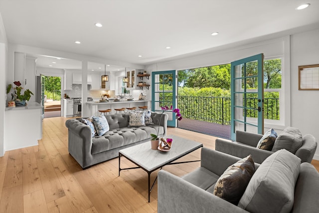 living area featuring a healthy amount of sunlight, light wood-type flooring, and recessed lighting