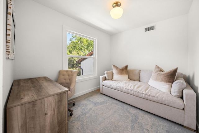 carpeted home office with visible vents and baseboards